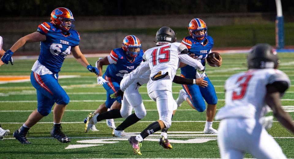 York High's Joden Nelson (64) blocks for quarterback Sam Stoner (11) during a football game between York High and Dover at Smalls Athletic Field, Friday, September 18, 2020. The Bearcats defeated the Eagles 45-7.