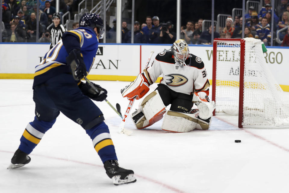 Anaheim Ducks goaltender John Gibson, right, deflects puck as St. Louis Blues' Alexander Steen, left, watches during the second period of an NHL hockey game Monday, Jan. 13, 2020, in St. Louis. (AP Photo/Jeff Roberson)