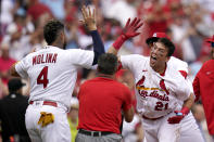 St. Louis Cardinals' Lars Nootbaar (21) is congratulated by teammate Yadier Molina (4) after hitting a walk-off single during the ninth inning to defeat the Chicago Cubs 4-3 in the first game of a baseball doubleheader Thursday, Aug. 4, 2022, in St. Louis. (AP Photo/Jeff Roberson)