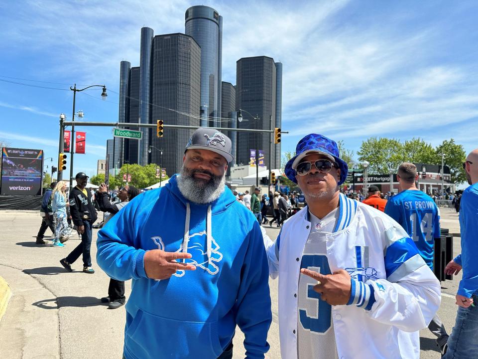 Art Walker and Joel Ewing stand together outside of the NFL Draft Experience near Hart Plaza