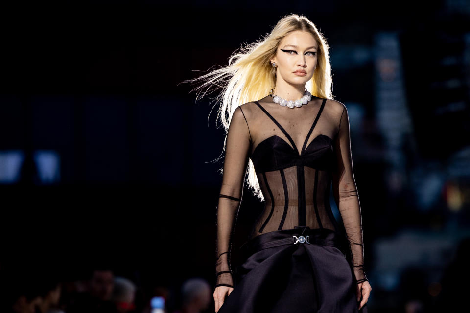 Gigi Hadid on the runway at Versace’s fall winter ’23 show in Los Angeles. - Credit: Emma McIntyre/Getty Images