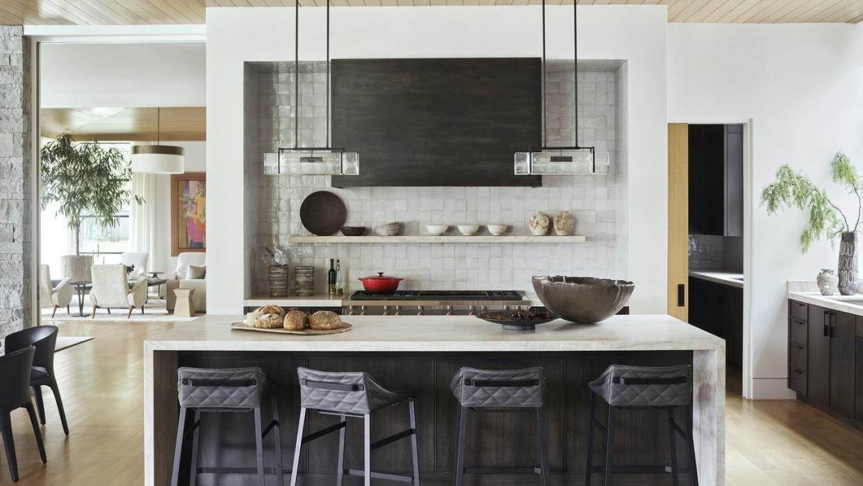 a parade of interesting textures warms the kitchen like quilted leather stools and glazed moroccan tilework