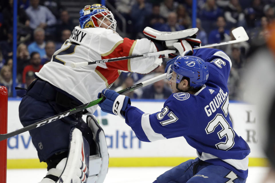 Tampa Bay Lightning center Yanni Gourde (37) crashes into Florida Panthers goaltender Sergei Bobrovsky (72) during the second period of an NHL hockey game Monday, Dec. 23, 2019, in Tampa, Fla. (AP Photo/Chris O'Meara)