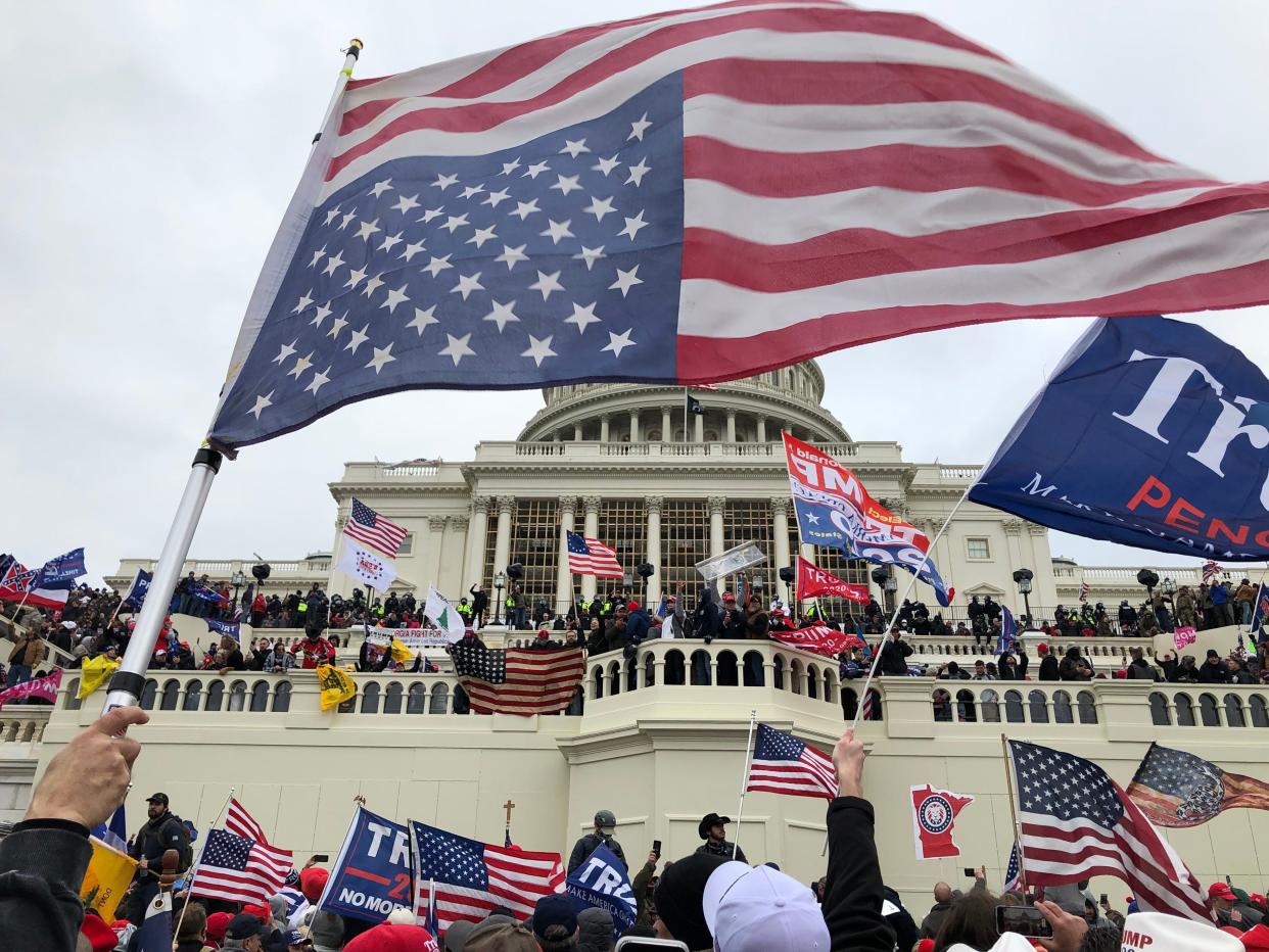 Rioters stand on the U.S. Capitol building to protest the official election of President-elect Joe Biden on Jan. 6, 2021 in Washington DC.