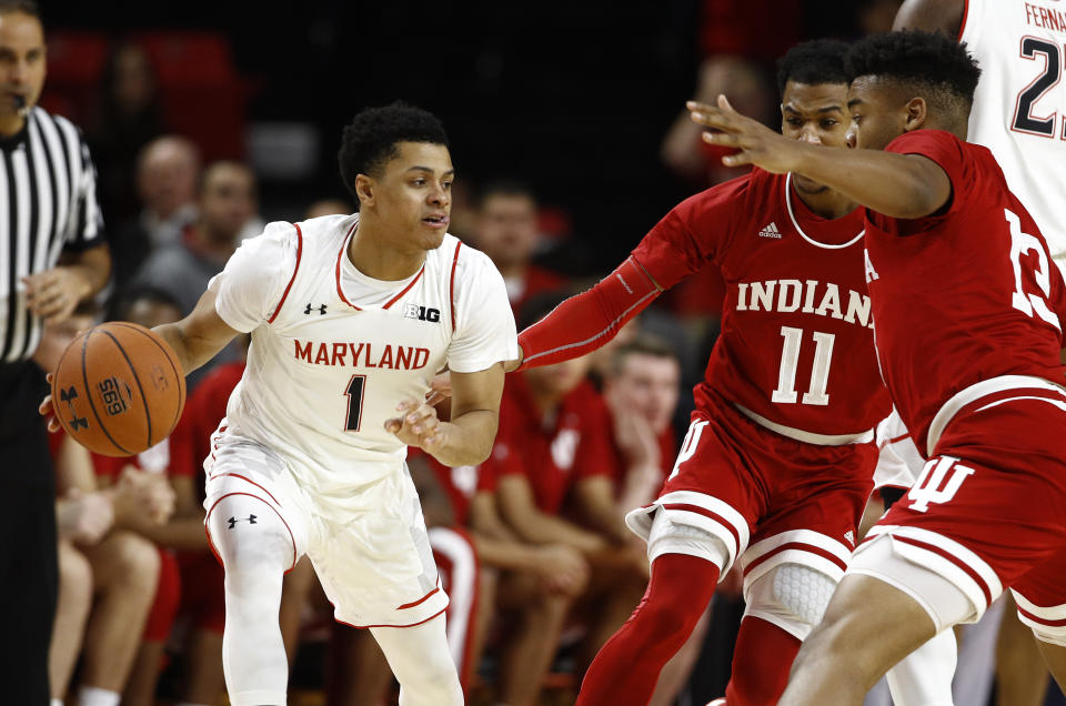 Maryland guard Anthony Cowan Jr., left, drives against Indiana guard Devonte Green (11) and forward Juwan Morgan in the first half of an NCAA college basketball game, Friday, Jan. 11, 2019, in College Park, Md. (AP Photo/Patrick Semansky)