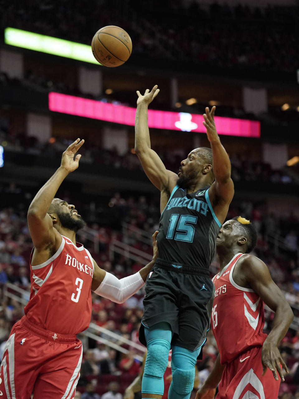 Charlotte Hornets' Kemba Walker (15) shoots as Houston Rockets' Chris Paul (3) and Clint Capela, right, defend during the first half of an NBA basketball game Monday, March 11, 2019, in Houston. (AP Photo/David J. Phillip)