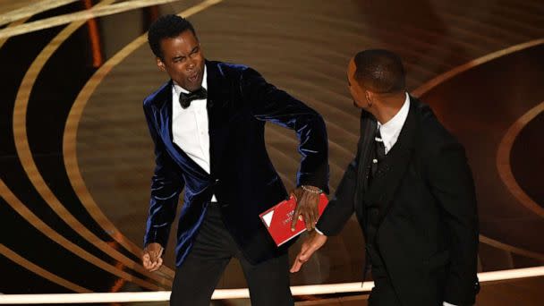 PHOTO: Will Smith, right, slaps Chris Rock onstage after Rock made a joke about Smith's wife Jada Pinkett Smith during the 94th Oscars at the Dolby Theatre in Hollywood, March 27, 2022.  (Robyn Beck/AFP via Getty Images)