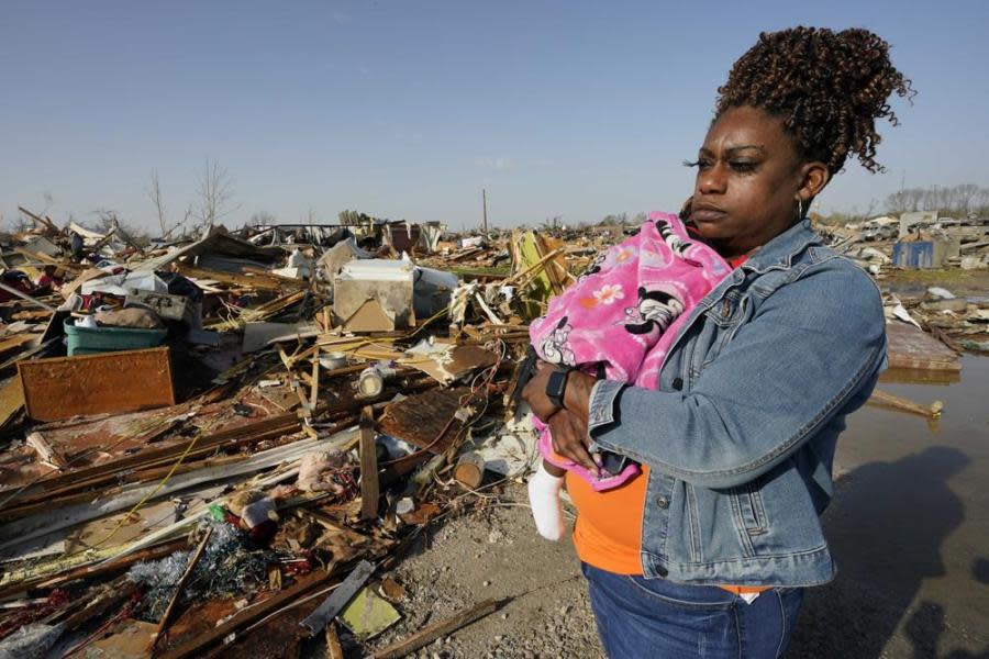 Wonder Bolden cradles her year-old granddaughter Journey Bolden as she surveys the remains of her mother’s tornado-demolished mobile home in Rolling Fork, Mississippi, Saturday, March 25, 2023. (AP Photo/Rogelio V. Solis)