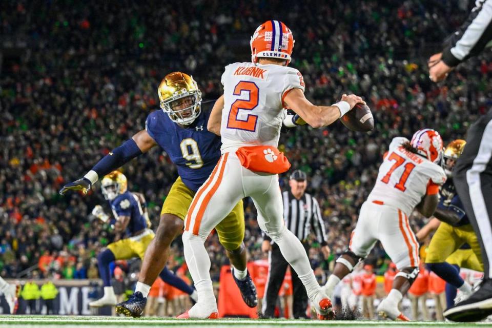 Nov 5, 2022; South Bend, Indiana, USA; Clemson Tigers quarterback Cade Klubnik (2) drops back to throw under pressure from Notre Dame Fighting Irish defensive lineman Justin Ademilola (9) in the third quarter at Notre Dame Stadium. Mandatory Credit: Matt Cashore-USA TODAY Sports