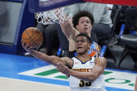 Denver Nuggets guard PJ Dozier (35) shoots in front oof Oklahoma City Thunder center Isaiah Roby during the second half of an NBA basketball game Saturday, Feb. 27, 2021, in Oklahoma City. (AP Photo/Sue Ogrocki)