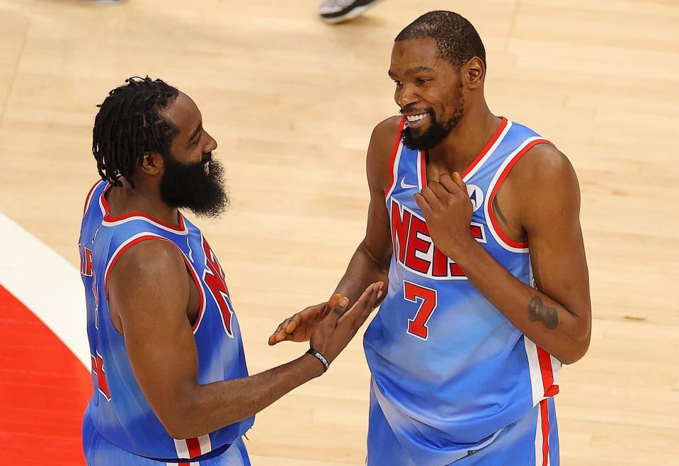 Could James Harden (left) and Kevin Durant lead the Nets to an NBA title even if Kyrie Irving misses the entire season?