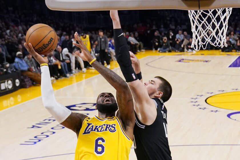 Los Angeles Lakers forward LeBron James, left, shoots as Los Angeles Clippers center Ivica Zubac defends during the first half of an NBA basketball game Tuesday, Jan. 24, 2023, in Los Angeles. (AP Photo/Mark J. Terrill)