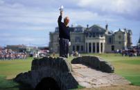 <p>Arnold Palmer of the USA waves to the crowd from the Swilken Bridge on the 18th hole during the second round of the British Open at St Andrews in Scotland. This proved to be a farewell from Palmer as shortly after the round he announced this would be his last British Open appearance. </p>