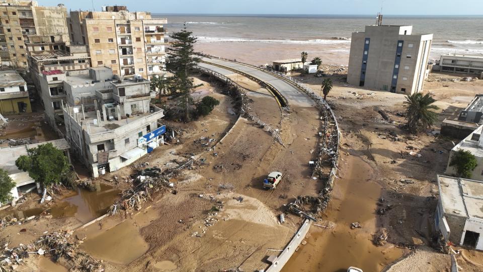 FILE - A damaged road is visible following storm Daniel in Derna, Libya, Sept. 12, 2023. This year’s COP28 in Dubai is likely to see more discussion about compensation for developing nations harmed by climate change. (AP Photo/Jamal Alkomaty)