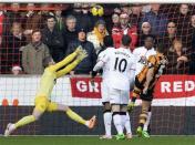 Hull City's James Chester (R) scores a goal against Manchester United during their English Premier League soccer match at the KC Stadium in Hull, northern England December 26, 2013. REUTERS/Nigel Roddis