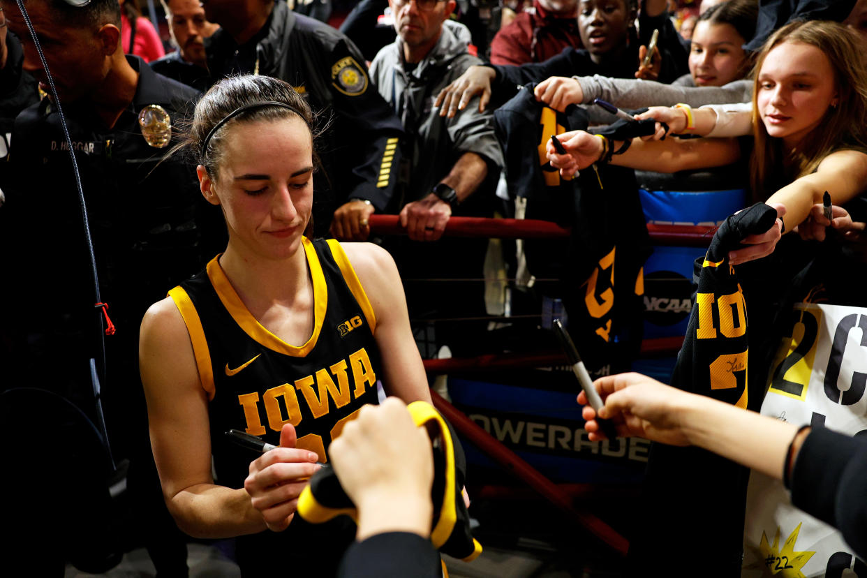 MINNEAPOLIS, MINNESOTA - FEBRUARY 28: Caitlin Clark #22 of the Iowa Hawkeyes signs autographs for fans after the game against the Minnesota Golden Gophers at Williams Arena on February 28, 2024 in Minneapolis, Minnesota. The Hawkeyes defeated the Golden Gophers 108-60. (Photo by David Berding/Getty Images)