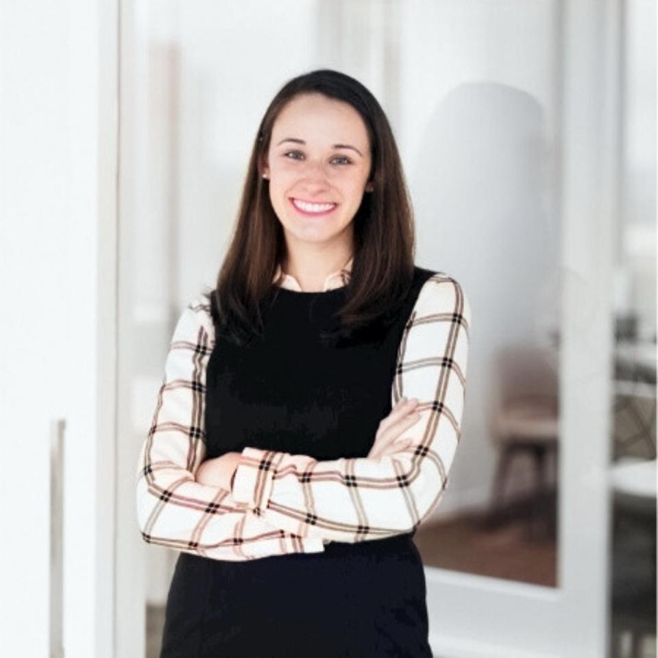 Stephanie Akhter stands, arms folded, in a portrait