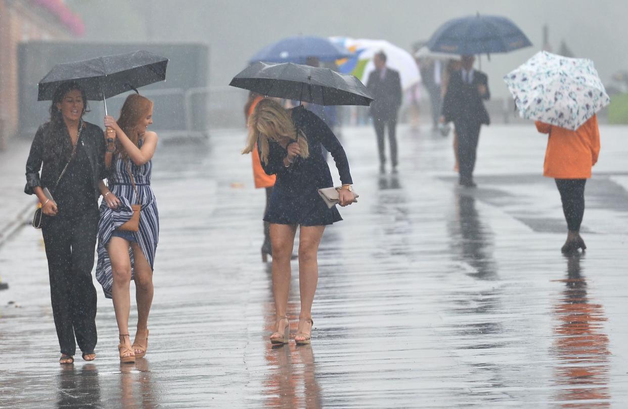 Racegoers get wet at York Races (Hugh Routledge/REX/Shutterstock)