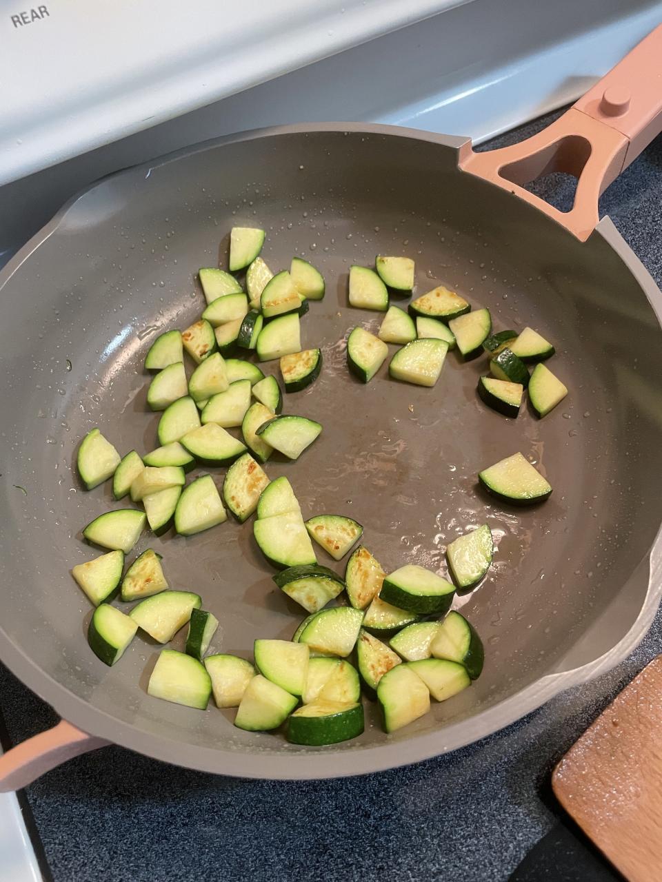 Zucchini squash wedges cooking in the pan