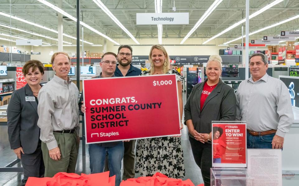 Sumner County Schools officials and others were on hand to receive a donation of $1,000 from the new reimagined Staples location.