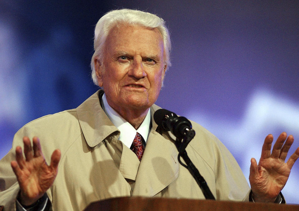 FILE - In this May 9, 2003, file photo, the Rev. Billy Graham quiets the crowd during the second day of his Mission San Diego revival at Qualcomm Stadium in San Diego. President Donald Trump has visions of establishing by the final months of his second term—should he win one—a “National Garden of American Heroes” that will pay tribute to some of the prominent figures in the nation’s history, including Rev. Graham, that he sees as the “greatest Americans to ever live.” The president unveiled his plan Friday, July 3, 2020, during his speech at Mount Rushmore National Memorial, S.D. (AP Photo/Denis Poroy, File)