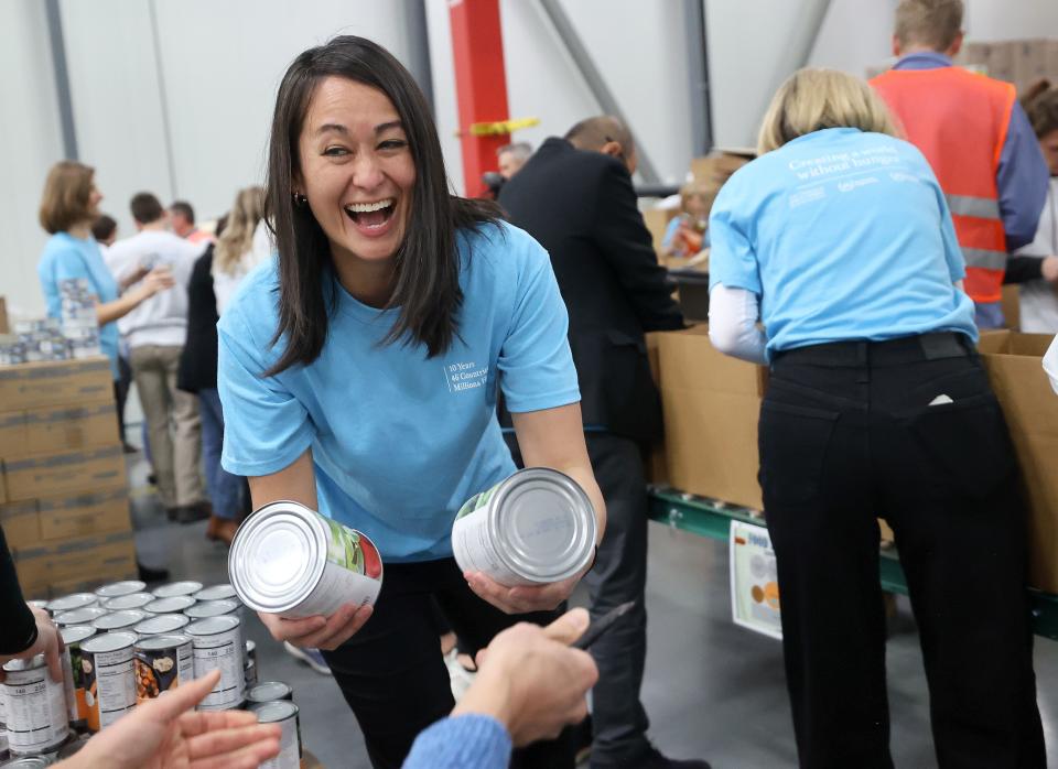 Sister Kristin M. Yee, second counselor in the Relief Society general presidency of The Church of Jesus Christ of Latter-day Saints, grabs canned food to add to food boxes during a service day, hosted by the church to commemorate the 10th anniversary of its relationship with the United Nations World Food Programme and World Food Program USA, at Bishops’ Central Storehouse in Salt Lake City on Thursday, Feb. 8, 2024. | Kristin Murphy, Deseret News