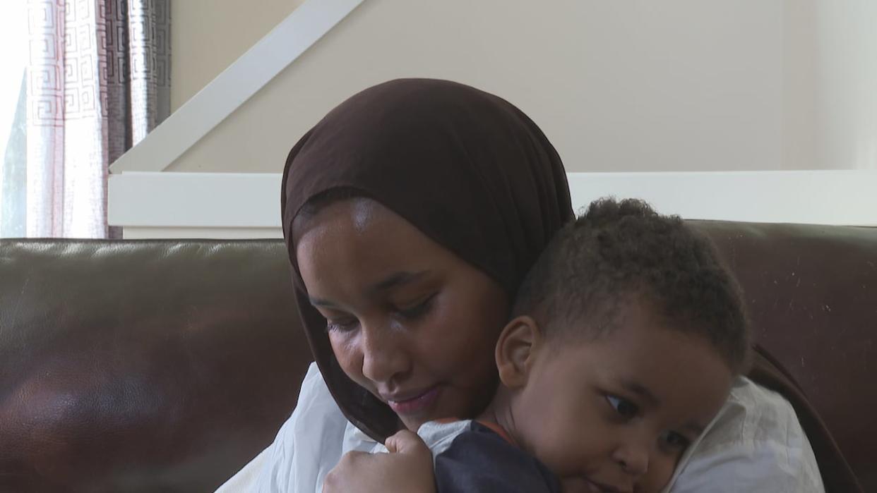 Halima Abdi and her youngest son, two-year-old Mubarak. (Travis McEwan/CBC News - image credit)