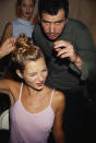 <p>A pink top knot was the rage for Kate Moss backstage at a fashion show, 1995</p>