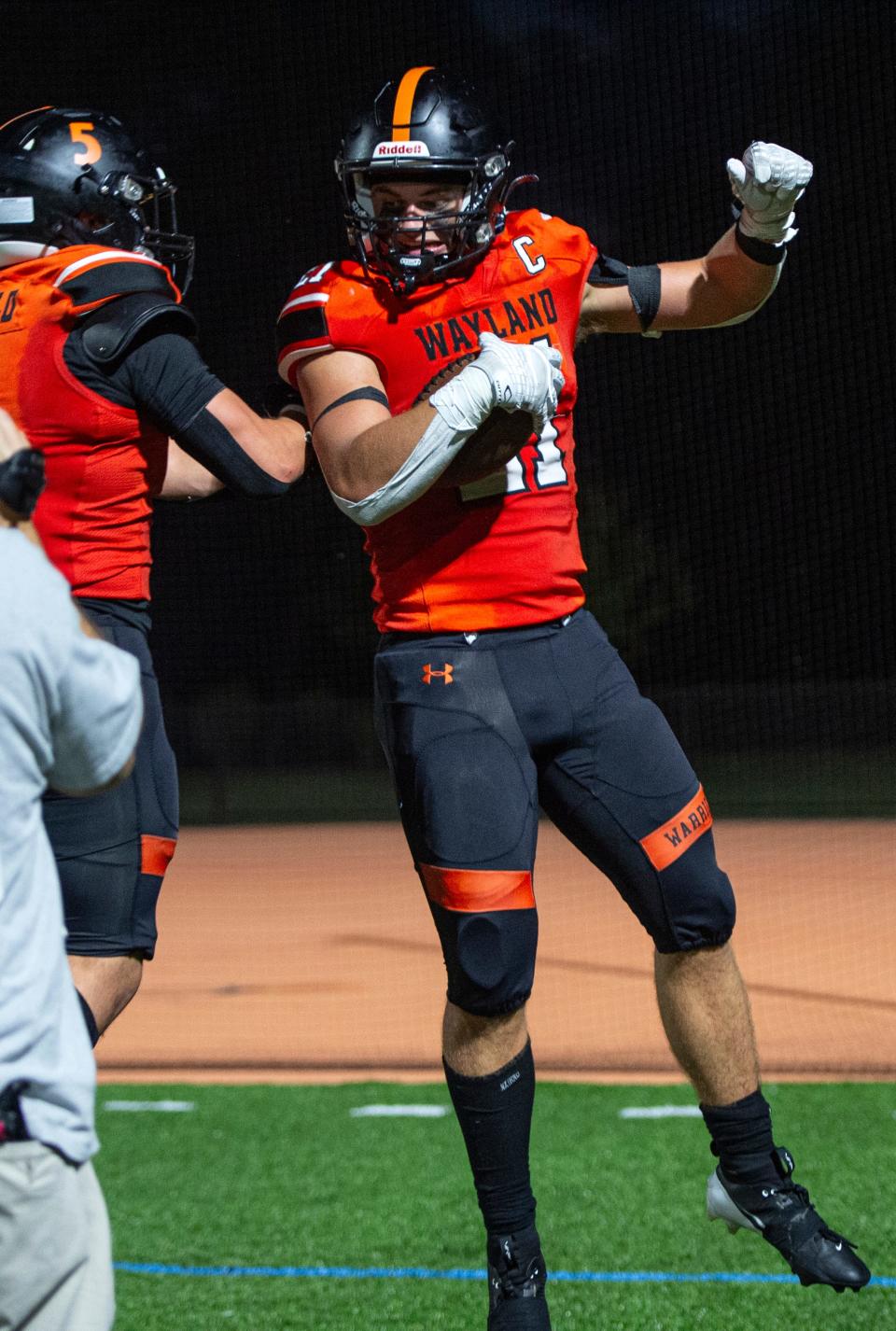 Wayland senior Max Dresens celebrates his touchdown with Wayland junior Michael Caulfield after putting the Warriors up 13-0, during the game in Wayland, Sept. 13, 2024. The Warriors shut out the Hillers, 30-0, and head coach Scott Parseghian picked up his 150th victory.