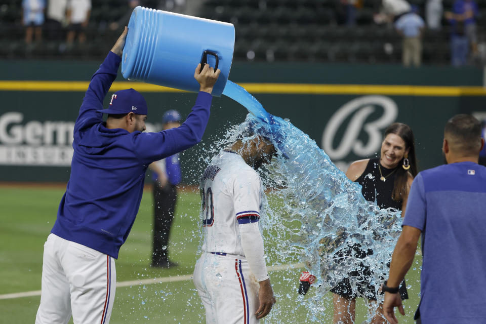 Texas Rangers' Martin Perez dunks Ezequiel Duran (20) after they defeated the Arizona Diamondbacks during a baseball game, Tuesday, May 2, 2023, in Arlington, Texas. (AP Photo/Michael Ainsworth)