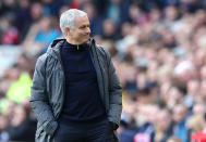 <p>Mourinho looks on with a smirk </p>