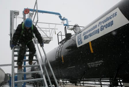 FILE PHOTO: Slade Whetro slides down a stairway alongside a railroad tank car loaded with ethanol at the Lincolnway Energy plant in Nevada, Iowa