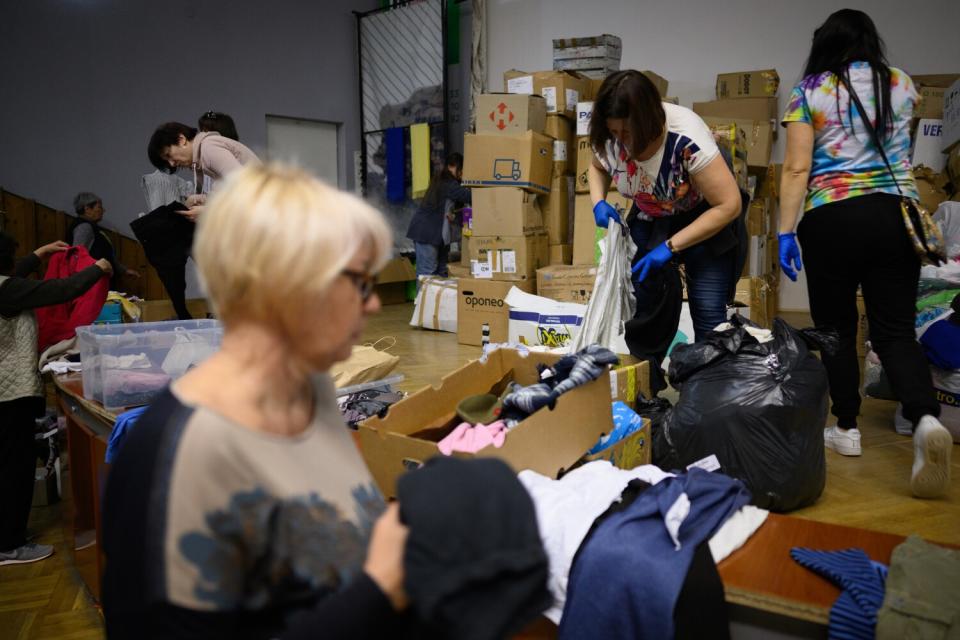 Volunteers sort through boxes of donated clothing