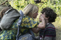 This image released by Paramount Pictures shows Noah Jupe, right, and Emily Blunt in a scene from "A Quiet Place Part II." The entertainment industry, a business predicated on drawing crowds in theaters, cinemas and concert venues, braced Thursday, March 12, 2020, for a potential shutdown from the coronavirus as upcoming movies were canceled, festivals scuttled and live audiences eliminated from television shows. John Krasinski, writer and director of “A Quiet Place 2," announced Thursday that his film from Paramount Pictures would not open next week as planned but be postponed to as yet-announced date. (Jonny Cournoyer/Paramount Pictures via AP)