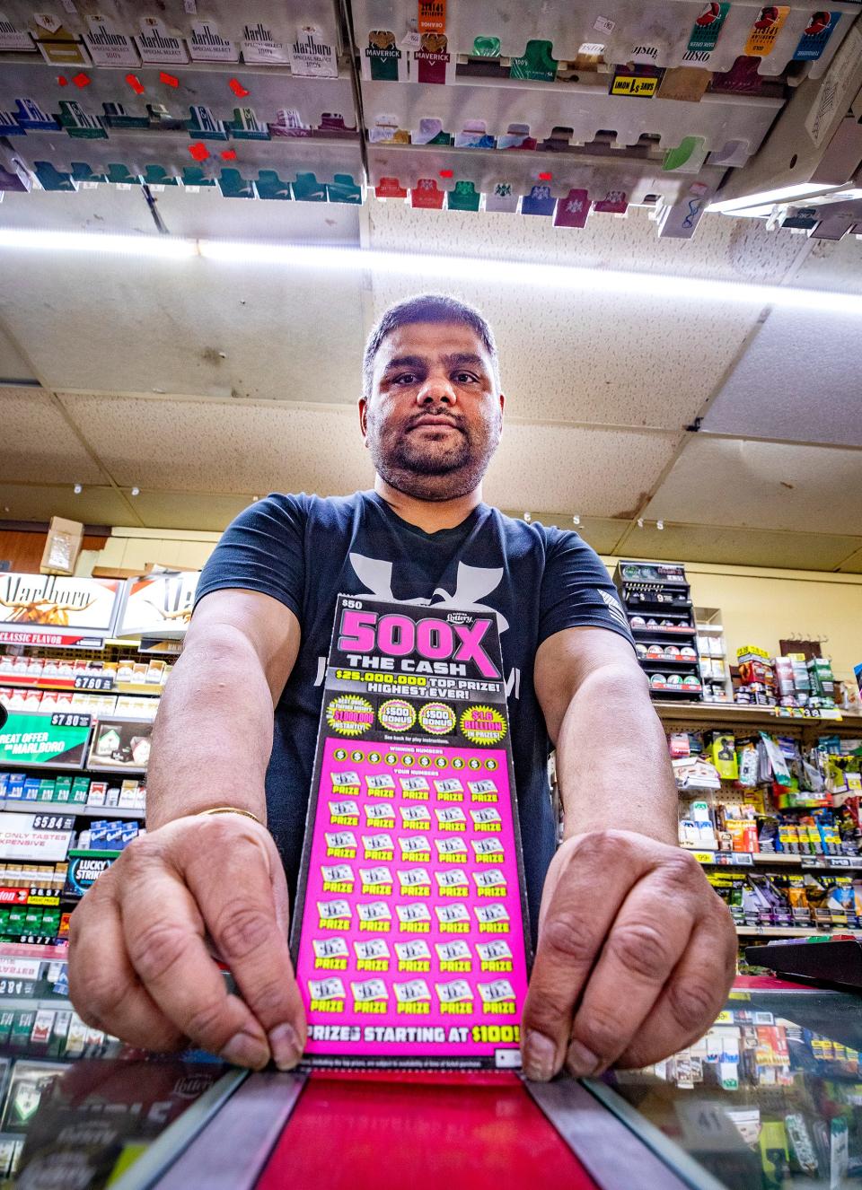 Hardy Chokshi, owner of Super Stop Food Store in Lakeland, holds a 500X The Cash scratch-off ticket at his store. The Florida Lottery introduced the first $50 scratch-off ticket last month. Chokshi said he sometimes sells 10 to 15 of the tickets a day.