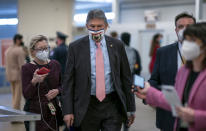 FILE - In this Feb. 25, 2021, file photo, reporters question Sen. Joe Manchin, D-W.Va., as he arrives for votes on President Joe Biden's cabinet nominees, at the Capitol in Washington. (AP Photo/J. Scott Applewhite, File)