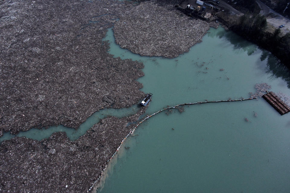 This aerial photo shows garbage floating in the Drina river near Visegrad, eastern Bosnia, Wednesday, Feb. 24, 2021. Environmental activists in Bosnia are warning that tons of garbage floating down the Balkan country's rivers are endangering the local ecosystem and people's health. The Drina River has been covered for weeks with trash that has piled up faster than the authorities can clear it out. (AP Photo/Kemal Softic)