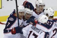 Columbus Blue Jackets' Jack Johnson (7) celebrates his goal with teammates in the first period of a first-round NHL playoff hockey game against the Pittsburgh Penguins in Pittsburgh on Wednesday, April 16, 2014.(AP Photo/Gene J. Puskar)