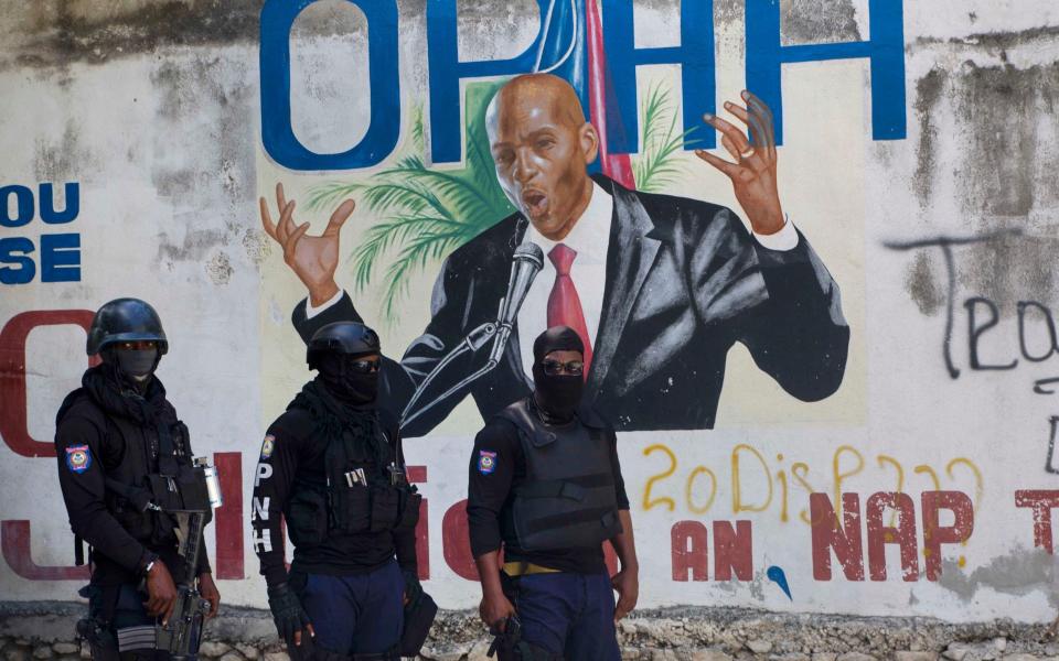  Police stand near a mural featuring Haitian President Jovenel Moise, near the leaderâ€™s residence where he was killed by gunmen in the early morning hours in Port-au-Prince, Haiti, Wednesday, July 7, 2021. (AP Photo/Joseph Odelyn) - Joseph Odelyn /AP