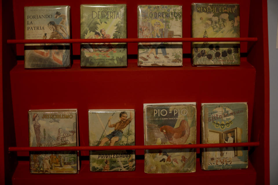 Children's books of the "Childhood and Peronism, the toys of the Eva Perón Foundation" exhibit are displayed at the Evita Museum in Buenos Aires, Argentina Wednesday, April 17, 2019. The foundation continued to exist after Evita's death in 1952, until a military coup toppled her husband, President Juan Domingo Perón, who went into exile for the following 18 years. (AP Photo/Natacha Pisarenko)