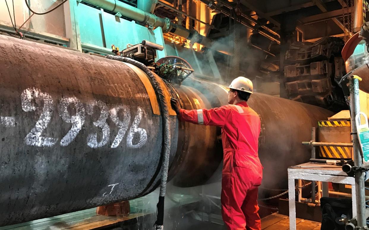 A specialist works onboard the Allseas' deep sea pipe laying ship Solitaire to prepare a pipe for Nord Stream 2 pipeline in the Baltic Sea - REUTERS/Stine Jacobsen/File Photo