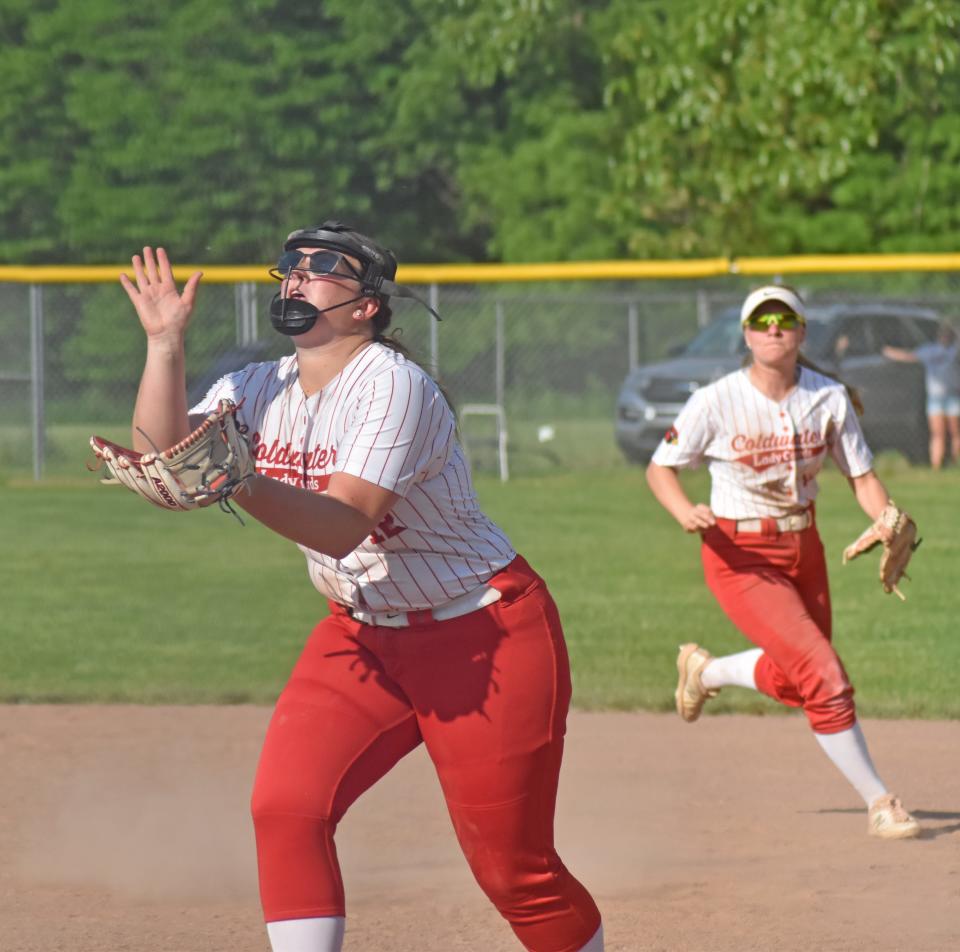 Coldwater's Alexis Bills camps under an infield fly from Marshall while teammate Rylee Rice looks on Tuesday.