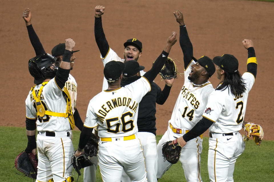 The Pittsburgh Pirates celebrate after getting the final out of a 2-1 win over the Cincinnati Reds in a baseball game in Pittsburgh, Saturday, April 22, 2023. (AP Photo/Gene J. Puskar)