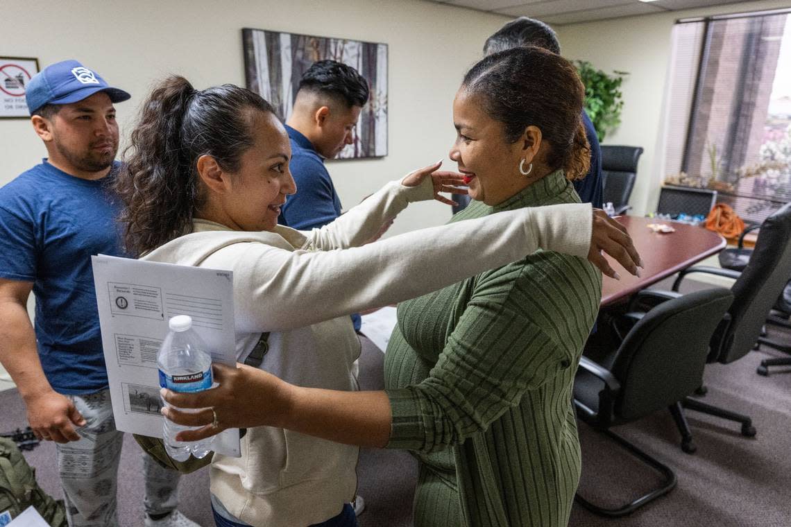 Diana Patterson, left, with the Sacramento ACT, hugs Margarita Yanez earlier this month after a discussion on the U Visa for victims of criminal activity in Sacramento. Since arriving in Sacramento, Yanez married her husband Jose Castellanos, shown at left, and is expecting their first child in December.