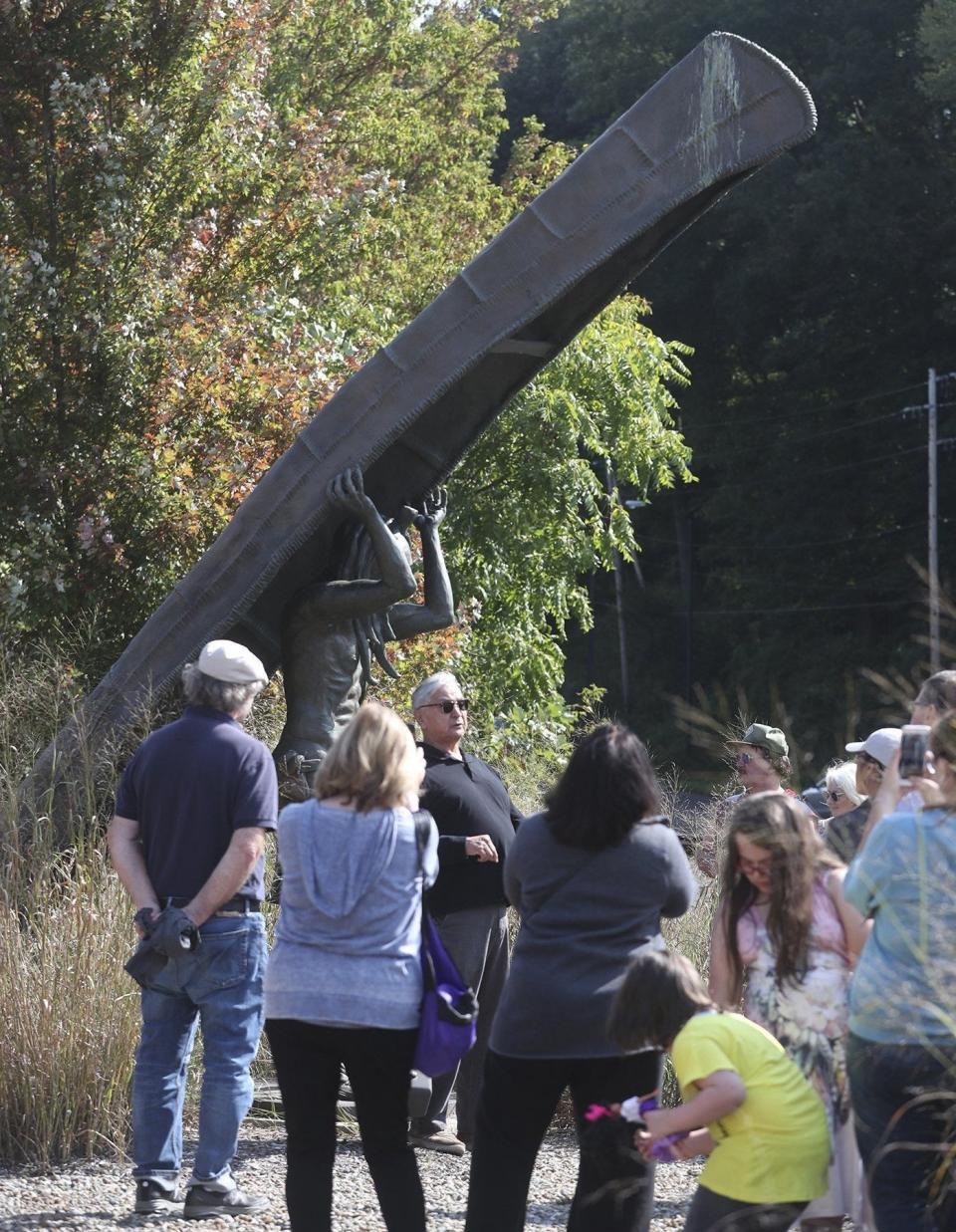 Artist Peter B. Jones talks about his statue "The Portage" at North Portage Path and Merriman Road during the 2019 North American First People's Day Commemoration in October 2019 in Akron