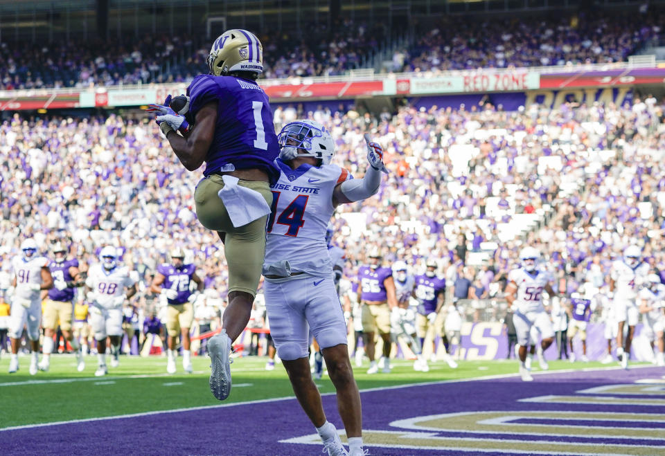 Washington wide receiver Rome Odunze (1) jumps up to make a touchdown catch against Boise State cornerback Kaonohi Kaniho (14) during the second half of an NCAA college football game Saturday, Sept. 2, 2023, in Seattle. (AP Photo/Lindsey Wasson)