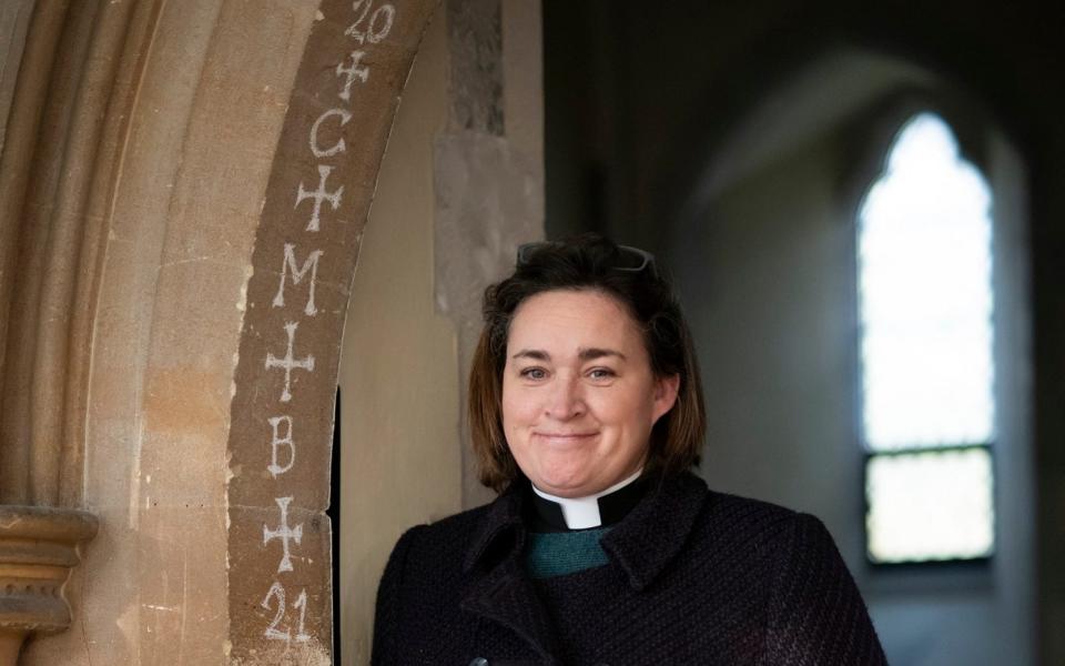 Mcc0098361. Revd. Arwen Folkes the rector of St Peters church chalks her church door as part of an epiphany tradition in Seaford, Sussex Wednesday January 06, 2021. Picture by Christopher Pledger for the Telegraph. - Christopher Pledger for the Telegraph