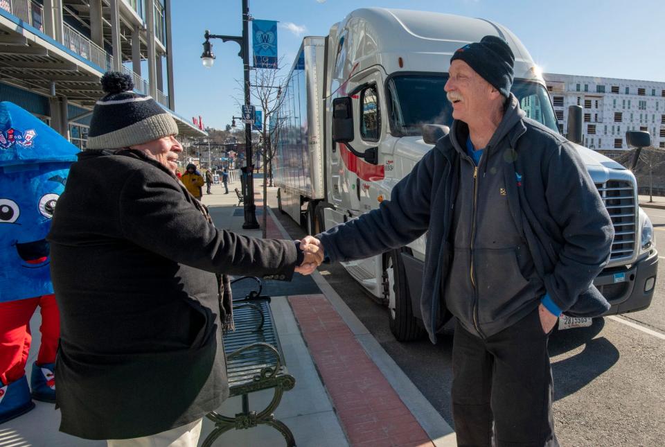 Worcester Red Sox President Dr. Charles Steinberg, left, greets Boston Red Sox equipment truck driver Al Hartz outside Polar Park Friday.