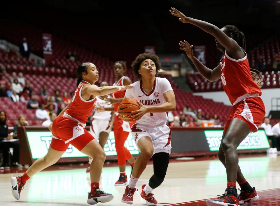 Houston guard Dymond Gladney (5) and Houston forward Fatou Diagne (45) defend as Alabama guard Megan Abrams (1) drives to the basket in Coleman Coliseum Friday, Dec. 3, 2021. [Staff Photo/Gary Cosby Jr]