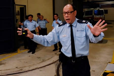 Police react as a police van carrying pro-democracy activists Joshua Wong and Agnes Chow enters the Eastern Court, in Hong Kong